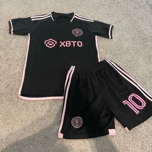 Men’s size small, pink and black Messi jersey and shorts set